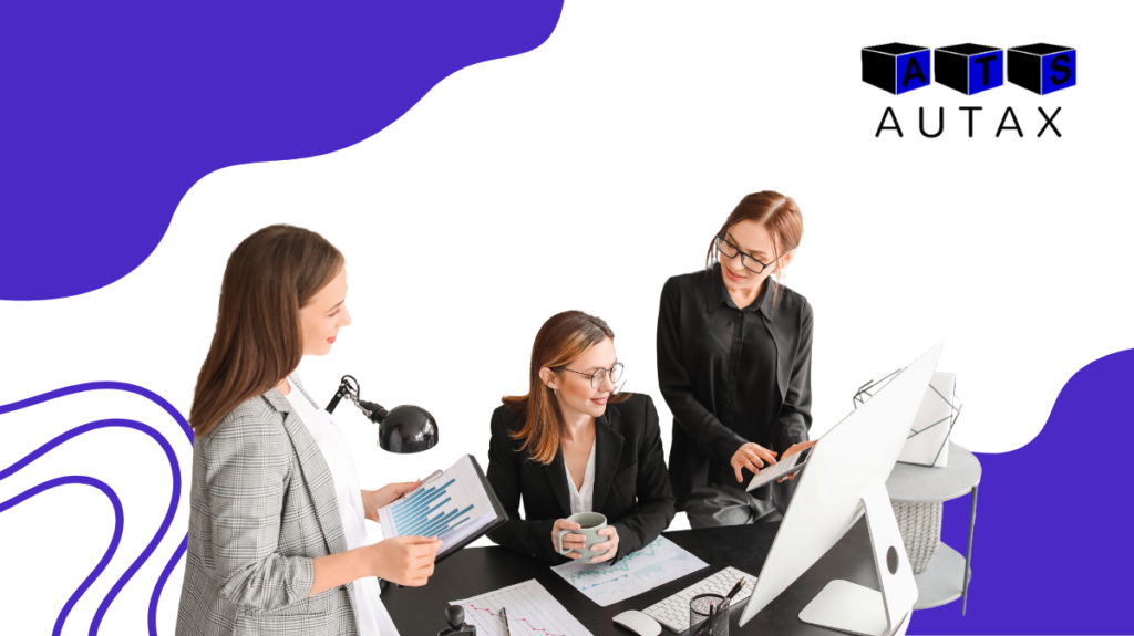 a group of women looking at a computer screen